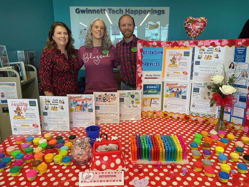 GTC staff behind an exhibit table