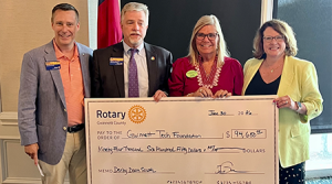 Darcie Johnson, GTC Foundation Executive Director, receiving donation check from Derby Down South Fundraiser