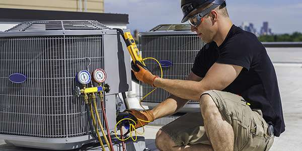 a man working on an HVAC unit