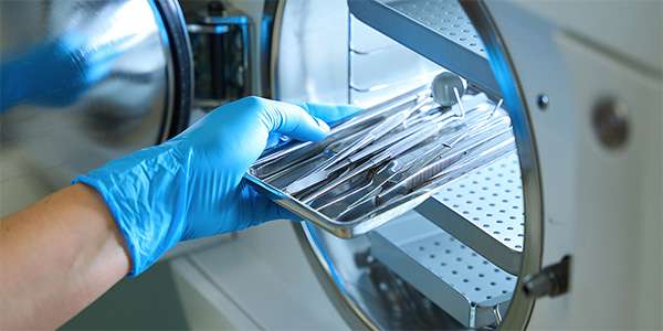 someone sterilizing surgical tools